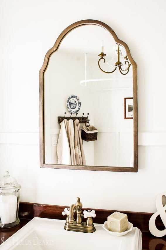 Farmhouse tour - love the brass faucet and mirror in this bathroom