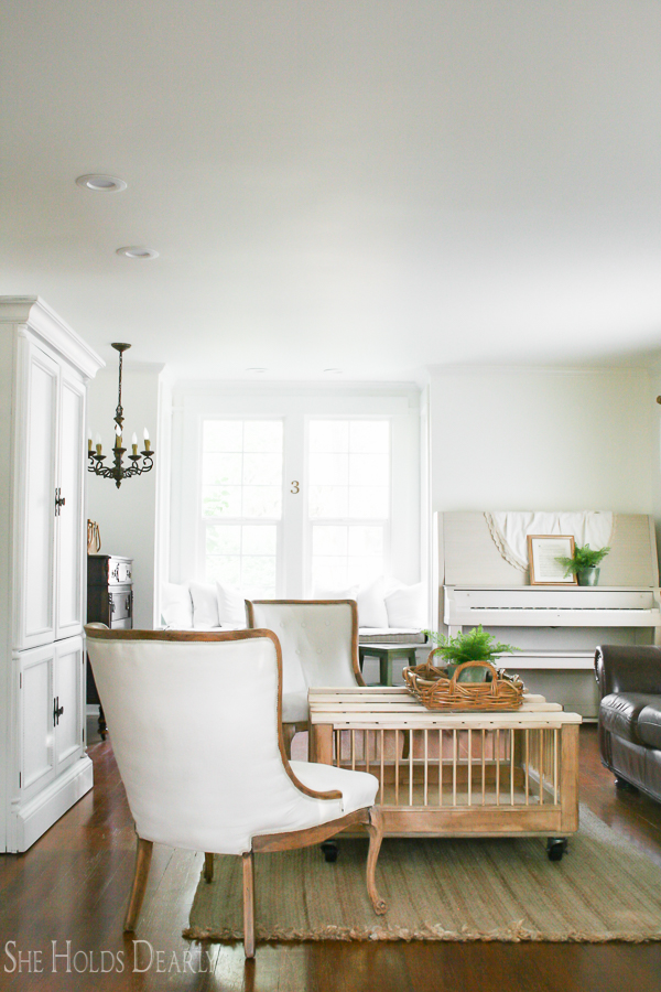 Farmhouse tour - love the white walls with touches of warm wood and the chicken coop coffee table