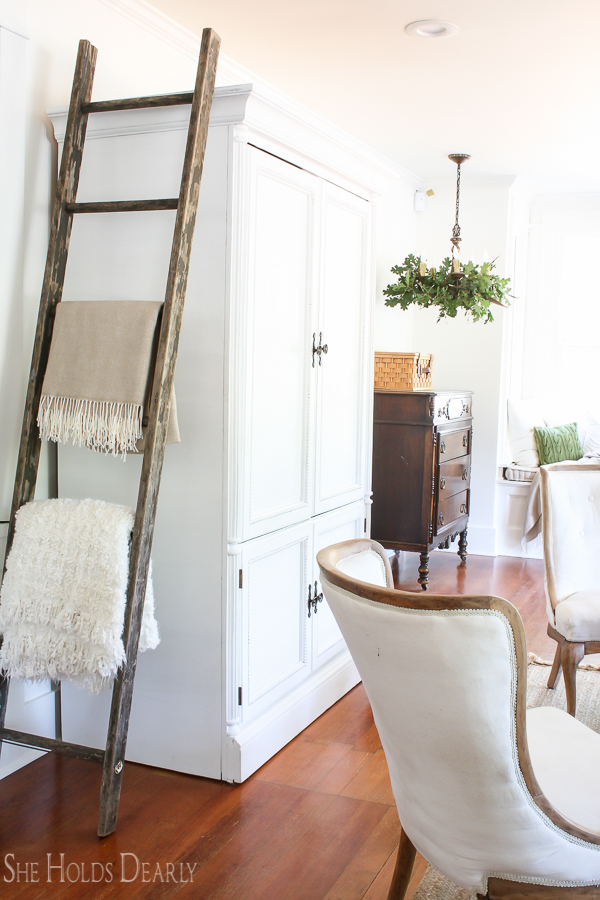 Farmhouse tour - love the old ladder for displaying blankets 