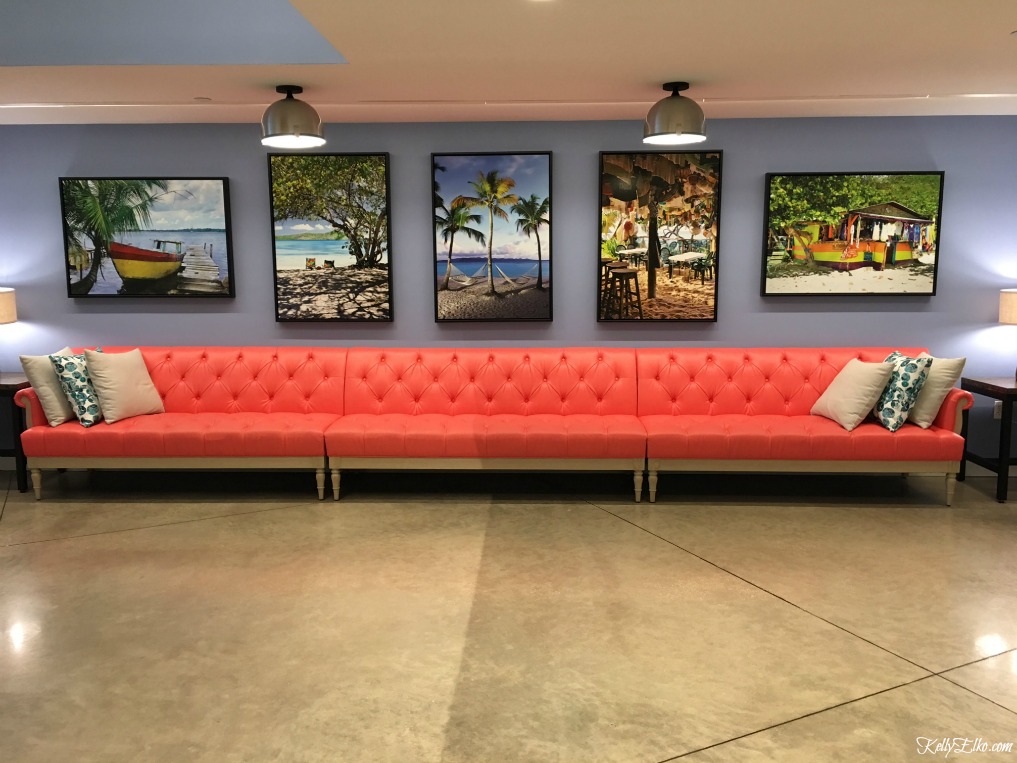 Pink sofa with tropical artwork kellyelko.com