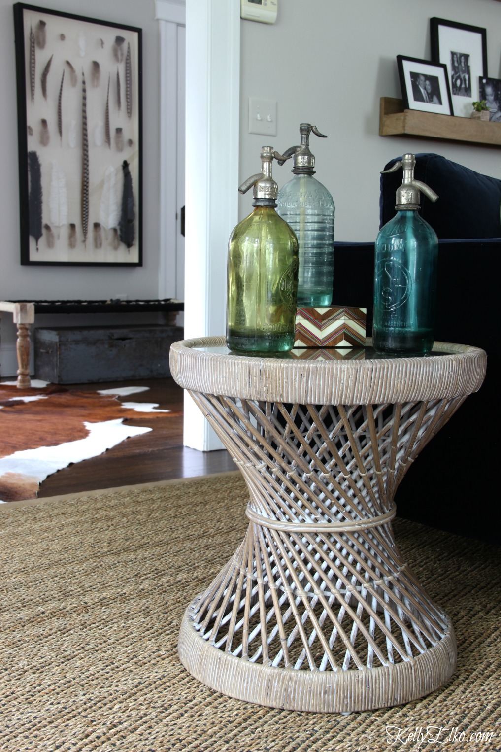 Collection of vintage seltzer bottles on a rattan table kellyelko.com