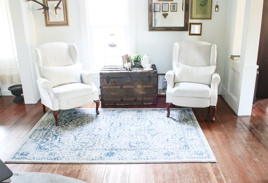 Farmhouse tour - love the pair of wingback chair and antique trunk