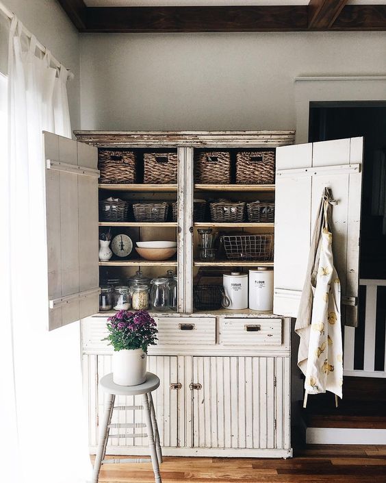 Farmhouse Tour - love this primitive cabinet for storage