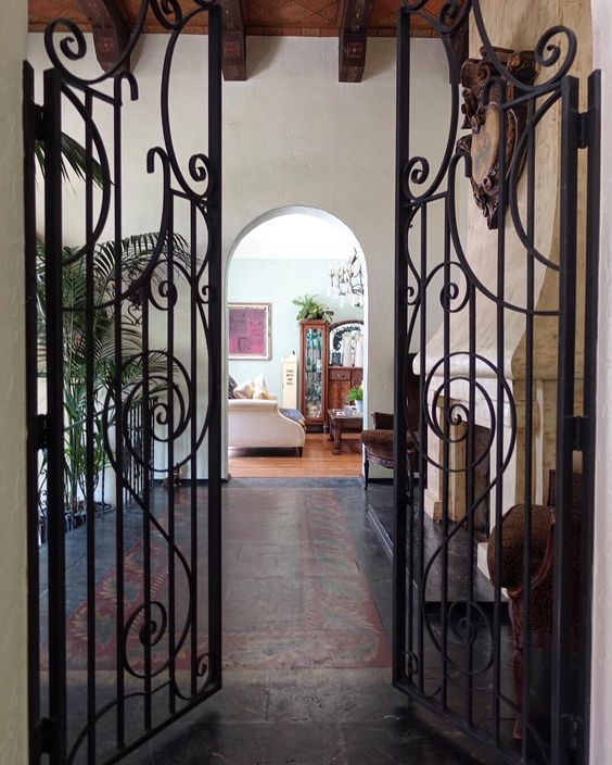 1927 house tour - love the antique iron gates, wood beam ceiling and tile floor 