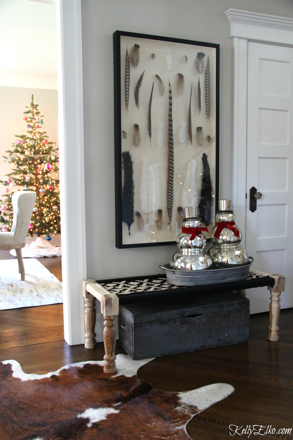 Christmas Home Tour - love this festive foyer with mercury glass snowmen kellyelko.com