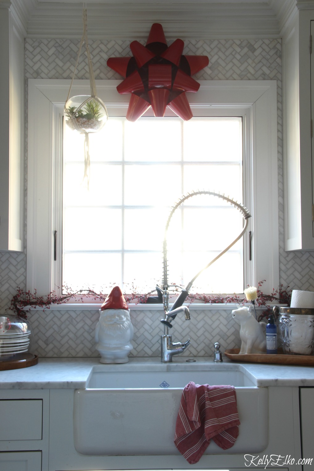 Christmas Kitchen - love the big red metal bow instead of a wreath kellyelko.com