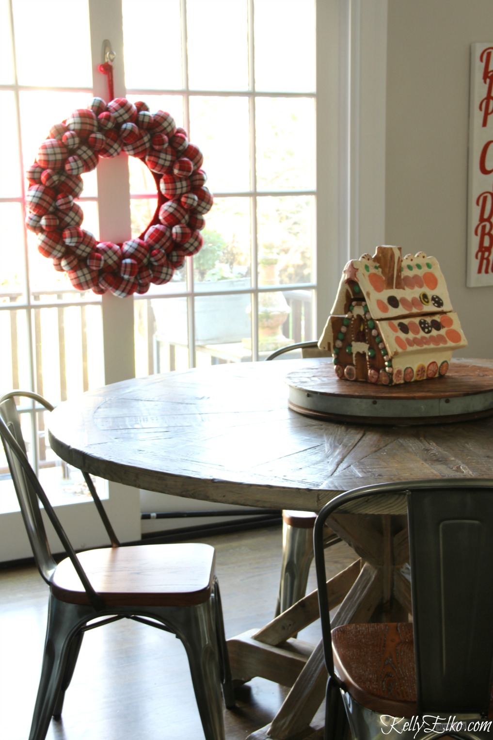 Christmas Kitchen - love this farmhouse table and chairs with giant plaid wreath kellyelko.com