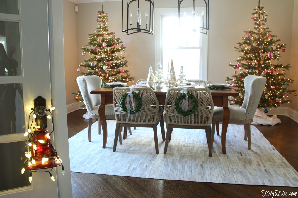 Christmas Home Tour - love the pair of Christmas trees in the dining room kellyelko.com