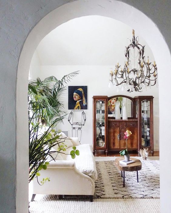 Boho eclectic living room - love the iron chandelier mixed with Moroccan rug and antique furniture