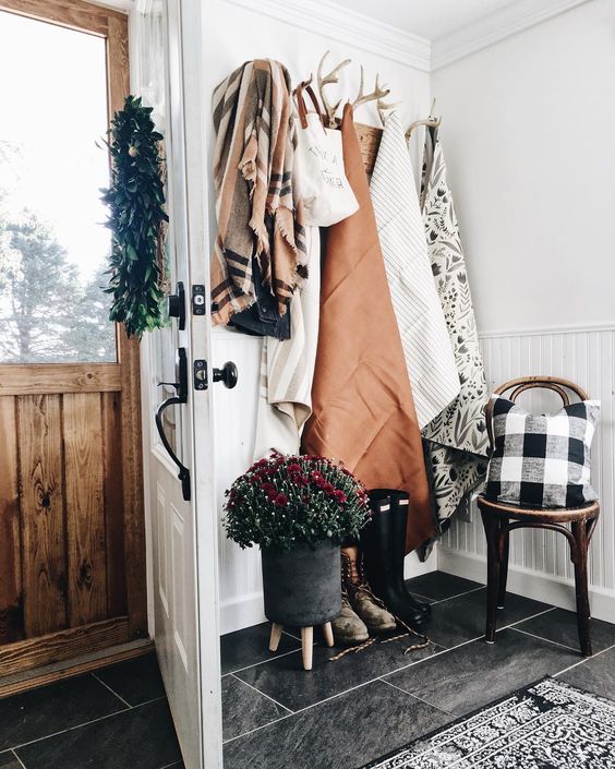 Farmhouse Tour - love the antler coat hooks in this entry