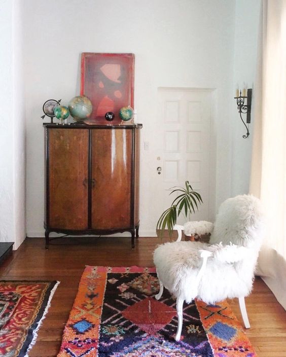 Eclectic Home Tour - love the colorful rugs and fur chair