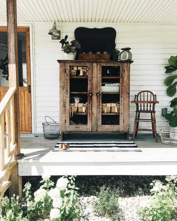 Farmhouse tour - love the porch with primitive cabinet 