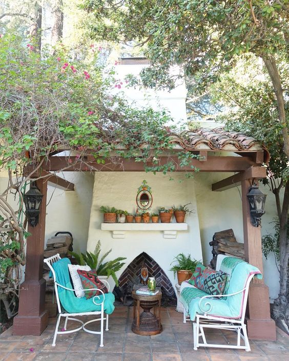 Spanish clay tiles on the roof add a quiet little spot for an outdoor fireplace