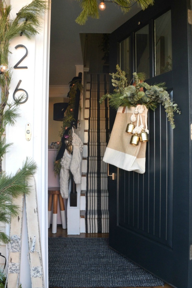 Creative Christmas Decorating Ideas - love this bag filled with greenery instead of the typical front door wreath