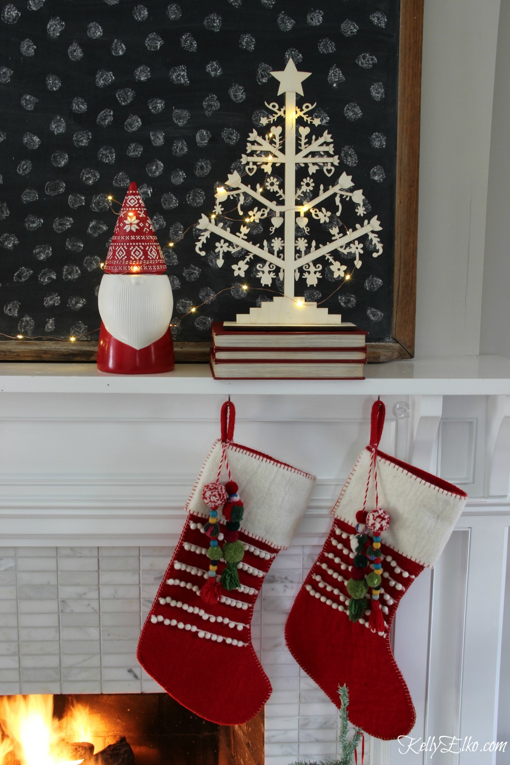 Christmas Home Tour - love this mantel with gnome and pom pom stockings kellyelko.com