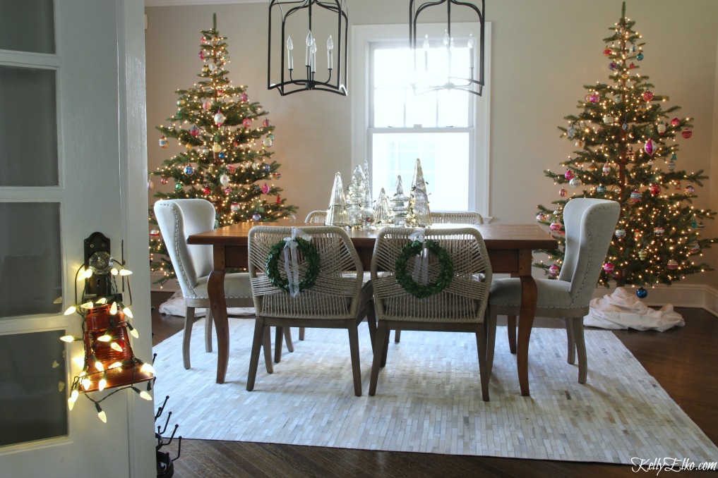 Love this pair of faux fir Christmas trees in the dining room kellyelko.com