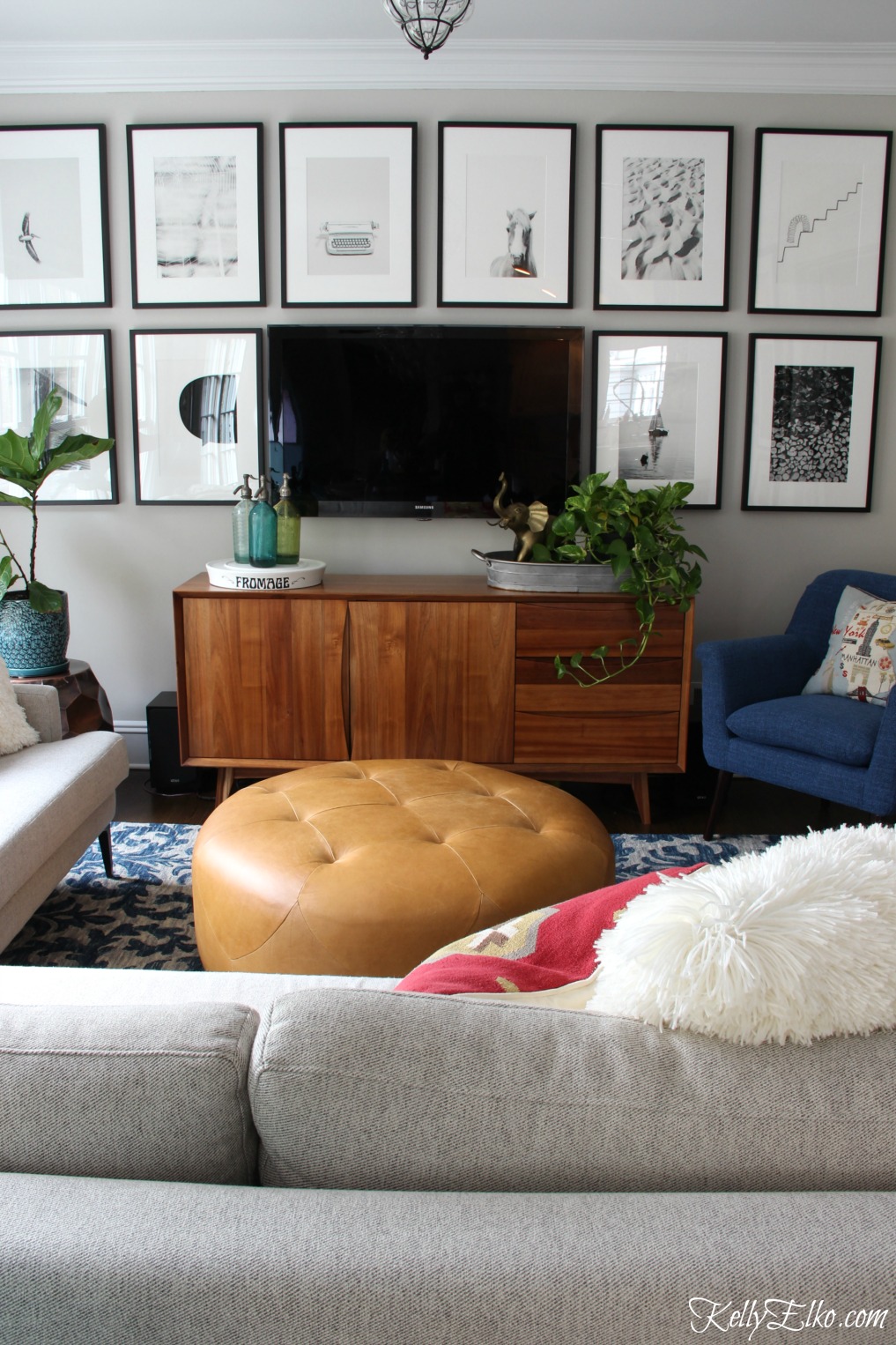 Love this black and white gallery wall around the tv kellyelko.com #gallerywall #blackandwhitephotography #blackandwhite #photography #minted #familyroom #cozy #familyroomdecor 