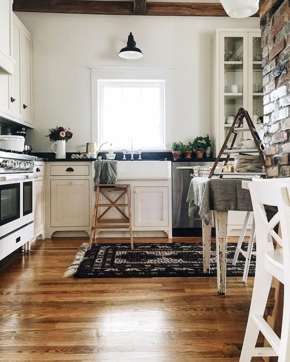 Farmhouse Tour - love this white kitchen with wood floors