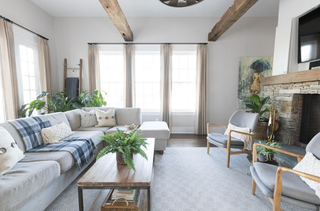 Eclectic Home Tour of Green Spruce Designs - love the warm gray paint, sectional sofa and antique wood ceiling beams in this cozy family room