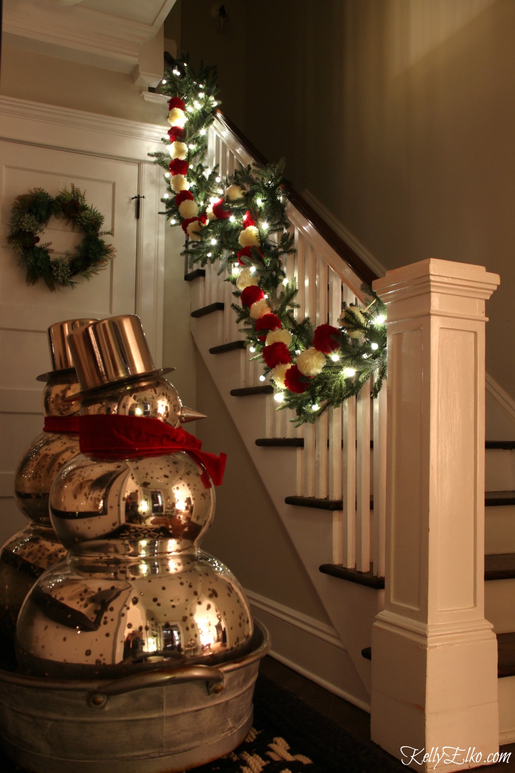 Christmas Nights Tour - see 25 of the best Christmas homes lit up at night! Love the garland on the bannister with pom poms and lights kellyelko.com #christmas #christmasdecorating #christmasdecor #christmaslights