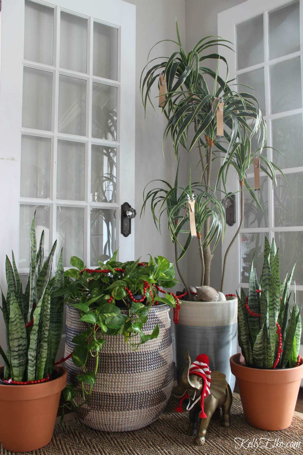 Simple Christmas decorating ideas - love the garland and ornaments in these everyday plants kellyelko.com