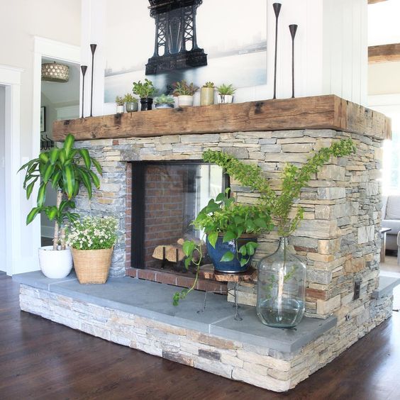 Eclectic Home Tour of Green Spruce Designs - how amazing is this double sided stacked stone fireplace with antique wood beam mantel 
