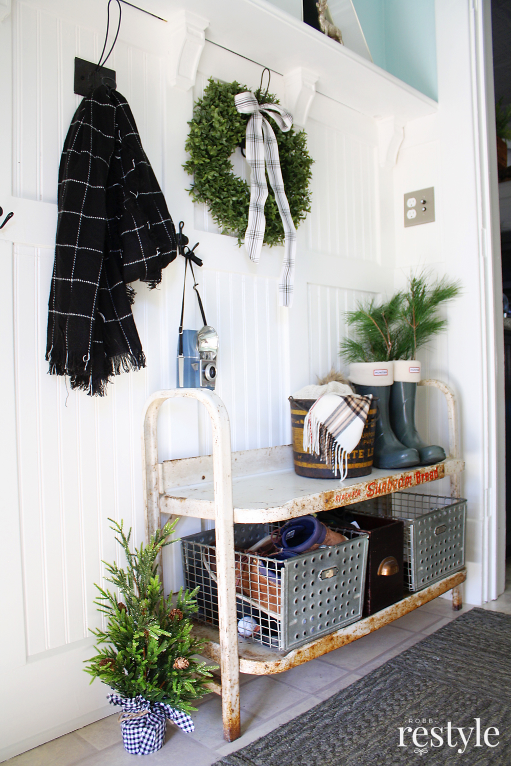 Eclectic Christmas Home Tour - wainscoting in the entry with vintage bread stand turned bench