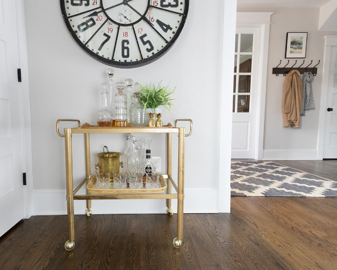 Eclectic Home Tour of Green Spruce Designs - love the vintage brass bar cart and huge clock