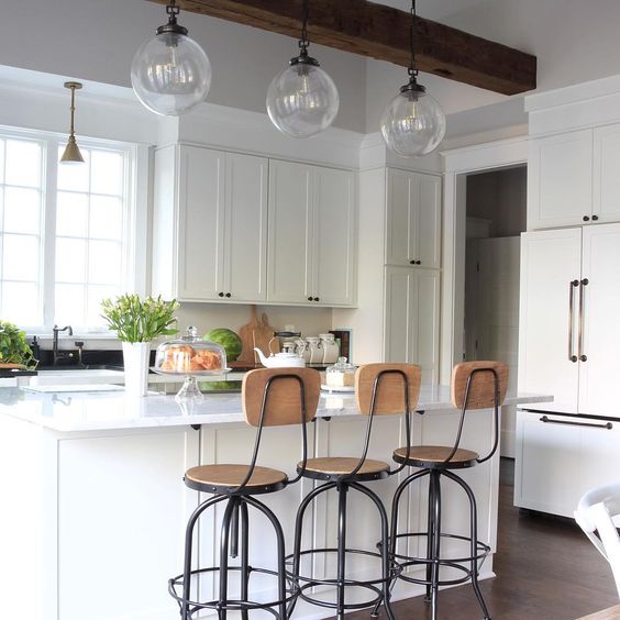 Eclectic Home Tour of Green Spruce Designs - love the white kitchen with vintage style wood barstools and glass lighting