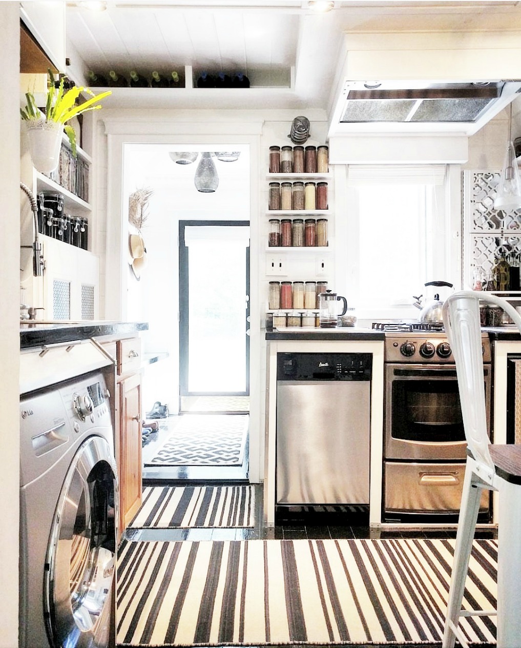 Eclectic Home Tour - Insieme House - tour this tiny house that has clever storage in this small kitchen laundry room combo 