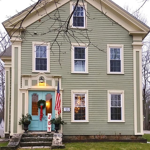 Eclectic Home Tour of Liv and Grace Restored - this 1851 historic home blends modern and vintage style and I love the green house paired with the blue front doors kellyelko.com