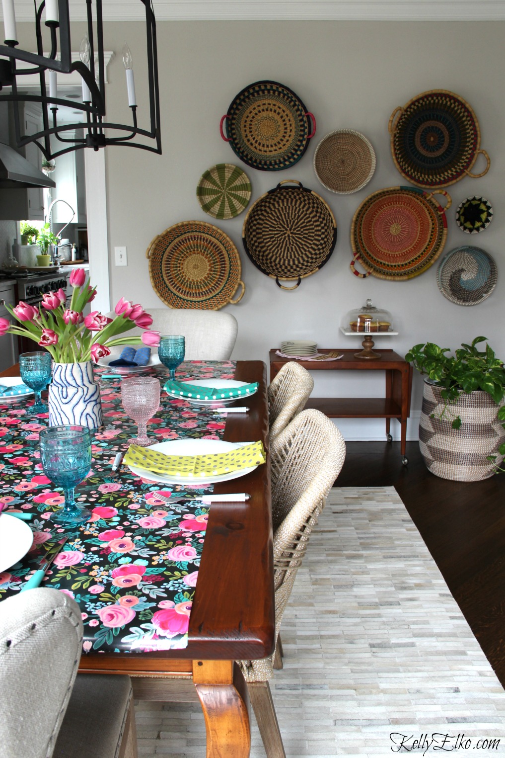 Spring Tablescape - love the floral table runner, pink and blue glasses and basket gallery wall kellyelko.com