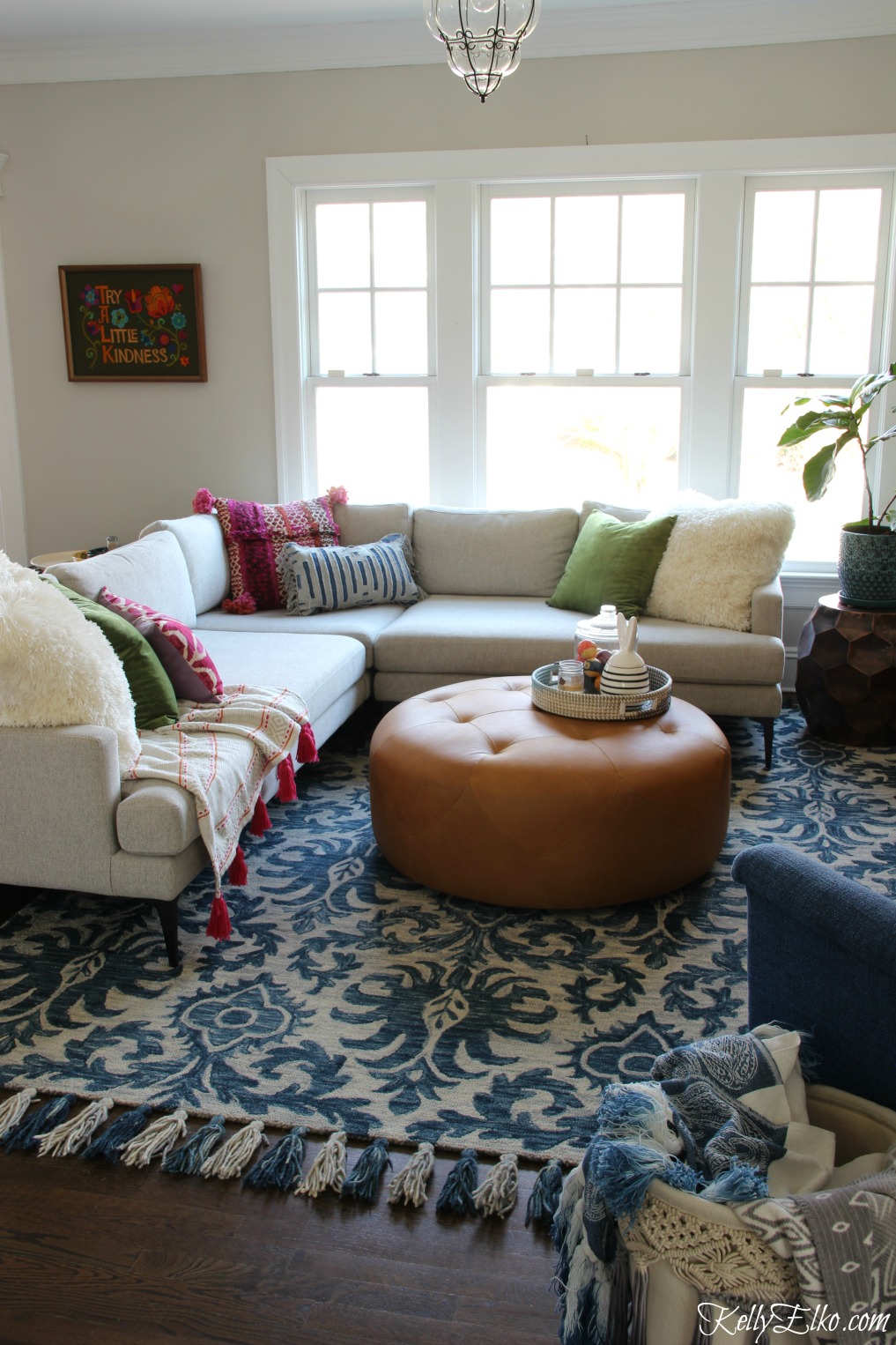 Love this spring family room in blues, pinks and greens kellyelko.com #familyroom #homedecor #sectional #bohodecor