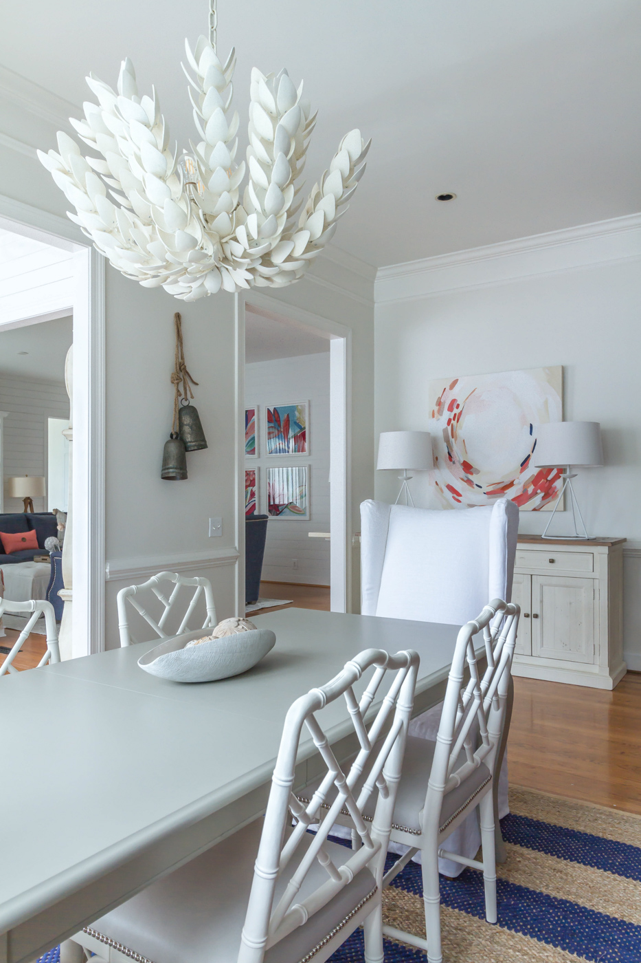 Eclectic Home Tour - statement chandelier and colorful art in a white dining room #diningroom #lighting #diningroomdecor