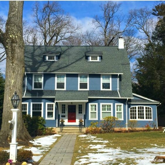 Blue House Exteriors - go bold with exterior paint like this beautiful blue with white trim and red front door kellyelko.com #bluehouses #bluepaint #curbappeal #bluehouse #paintcolors #exteriorpaint #blueexteriors