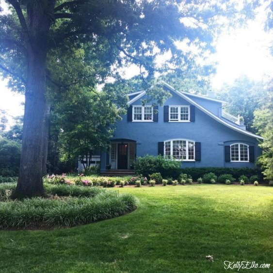 Blue House Exteriors - go bold with exterior paint like this blue stucco home with white trim and black shutters kellyelko.com #bluehouses #bluepaint #curbappeal #bluehouse #paintcolors #exteriorpaint #blueexteriors
