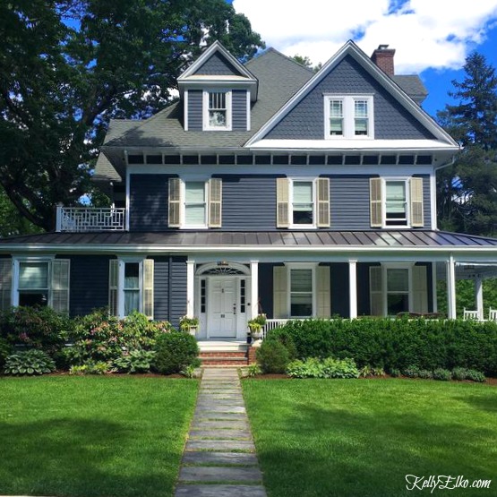 Blue House Exteriors - go bold with exterior paint like this dark blue with white trim and metal roof kellyelko.com #bluehouses #bluepaint #curbappeal #bluehouse #paintcolors #exteriorpaint #blueexteriors