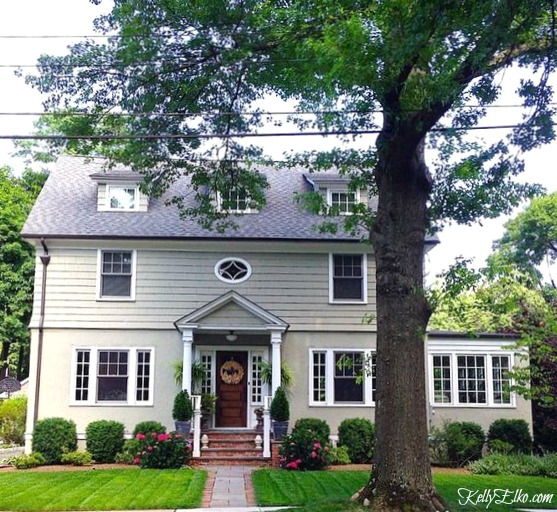 Old house with green paint - love the dormers, front porch and landscaping kellyelko.com #oldhouse #curbappeal #paintcolors #exteriorpaint 