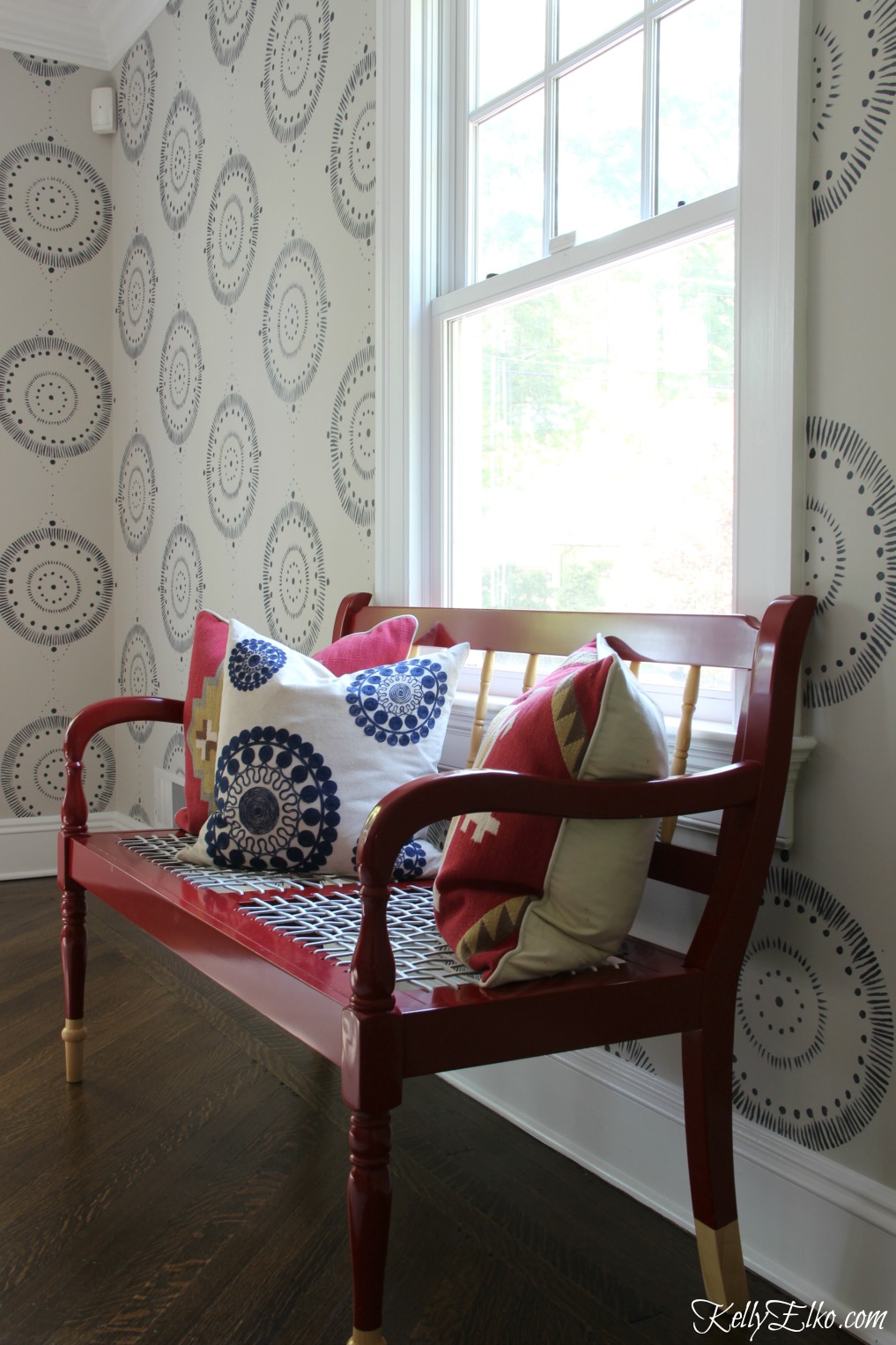 Forget wallpaper! This hand painted mural is like faux wallpaper minus the expense. Love the pop of red from the bench kellyelko.com #wallpaper #mural #diningroom #wallart #handpainted 