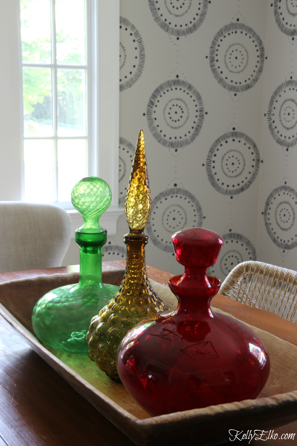 Forget wallpaper! This hand painted mural is like faux wallpaper minus the expense and I love the mid century decanters in an old dough bowl kellyelko.com #wallpaper #mural #diningroom #wallart #handpainted 