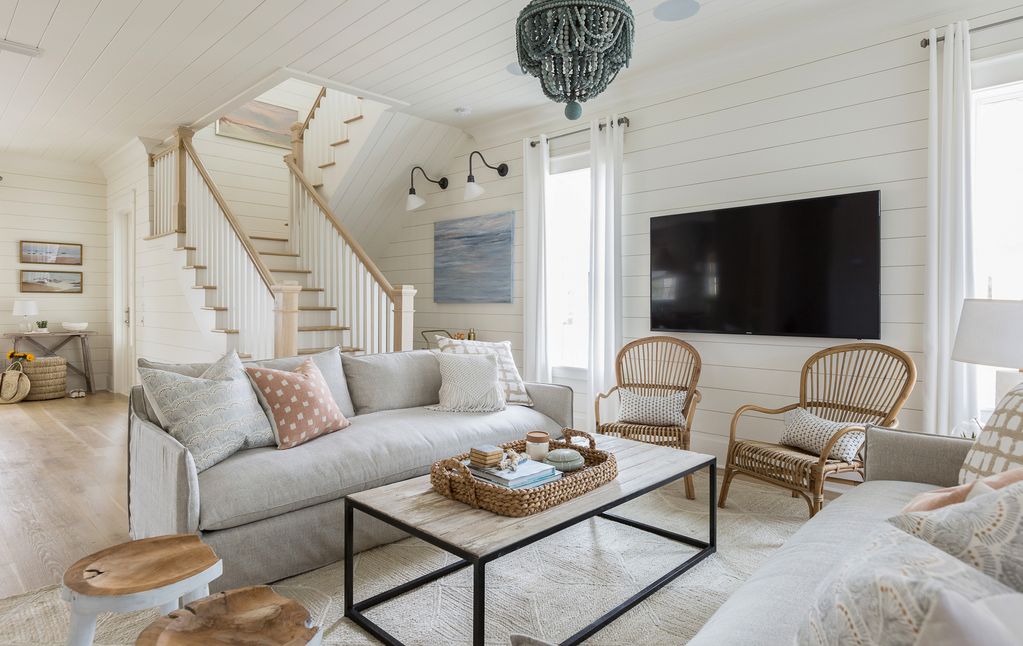 What a gorgeous home! Love the neutral family room with blue beaded chandelier and the texture from natural wood and rattan kellyelko.com #housetour #homedecor #familyroom #coastalstyle #decorate #interiors