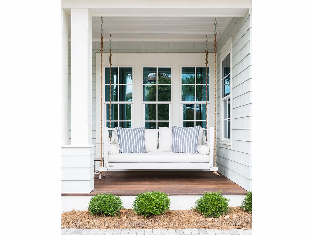 Beautiful home tour of this coastal home with hanging porch swing kellyelko.com #porch #porchdecor #farmhousestyle