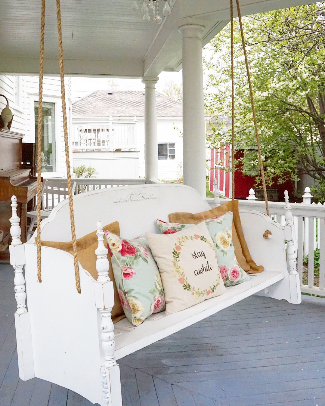 Turn an old bed into a DIY porch swing kellyelko.com #DIY #diyideas #porch #porchswing #farmhousestyle