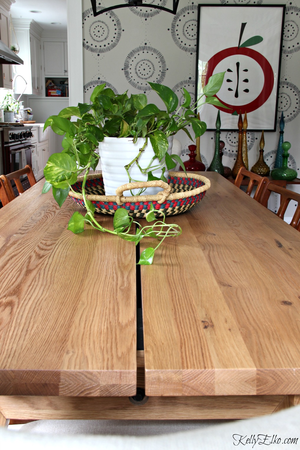 Love this solid oak dining table that's extendable to seat 12! kellyelko.com #diningroom #diningtable #diningroomfurniture #mural #centerpiece 