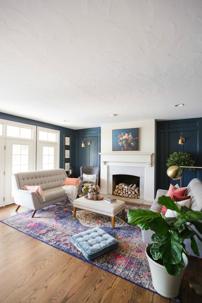 Love this blue living room with colorful rug kellyelko.com #livingroomdecor #familyroomdecor #bluepaint #eclecticstyle #interiordecorate #interiordecor