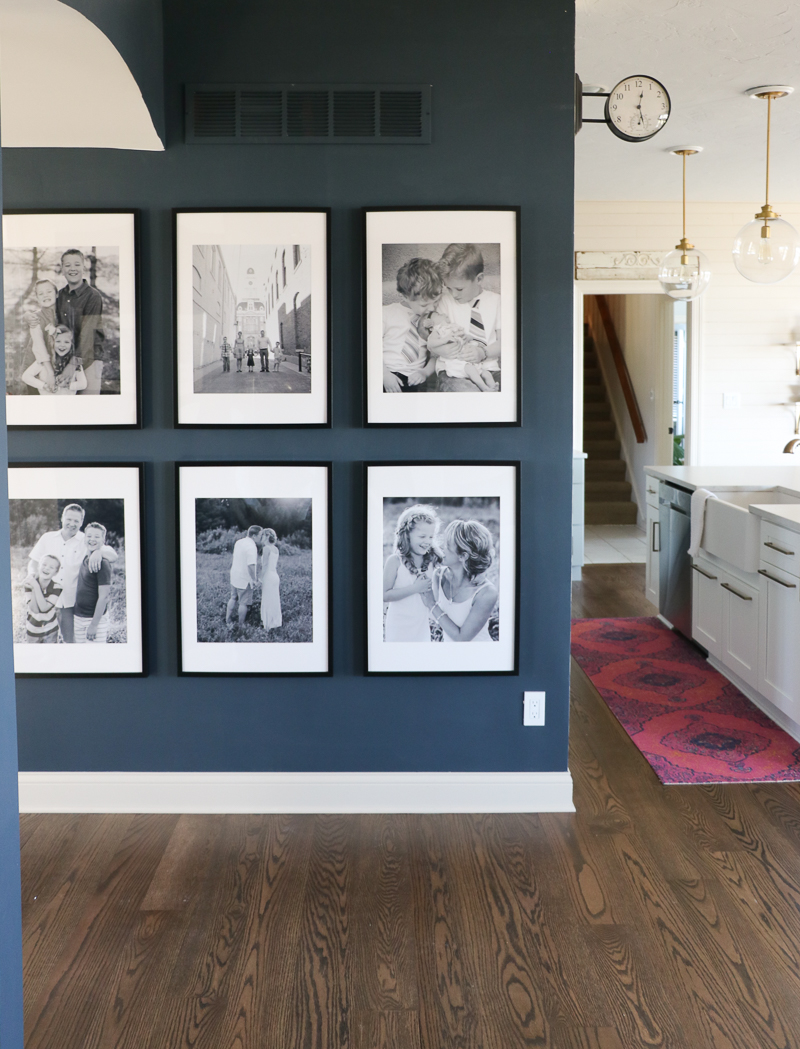 Eclectic Home Tour complete with oversized family gallery wall on dark blue walls kellyelko.com #blue #gallerywalls #familyphotos #hometour