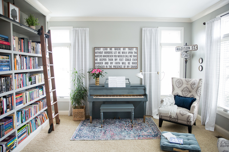 Colorful home tour - love the built in bookcase with rolling library ladder kellyelko.com #bookcase #library #diyideas #homeoffice #bookshelves