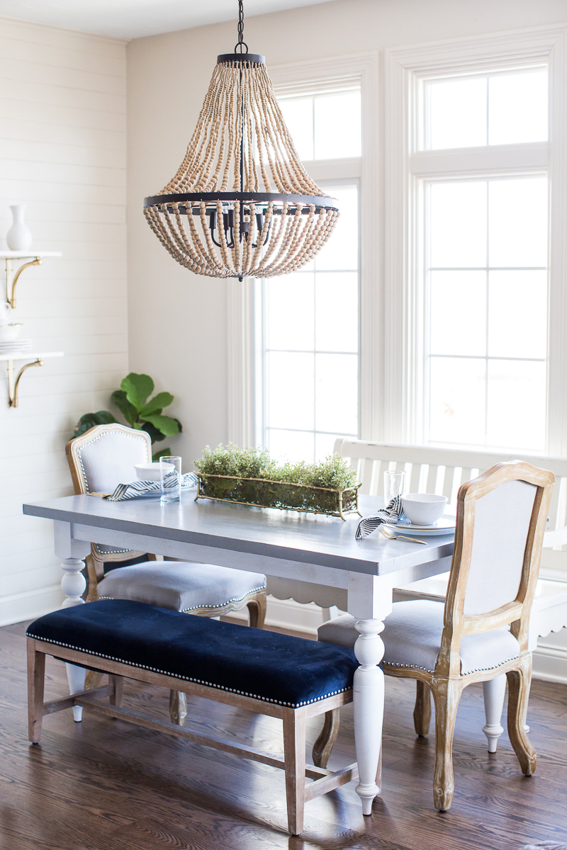 Love this eat in breakfast nook with beaded chandelier and mismatched chairs kellyelko.com #kitchen #kitchendecor #farmhousekitchen #kitchenfurniture #lighting #chandelier