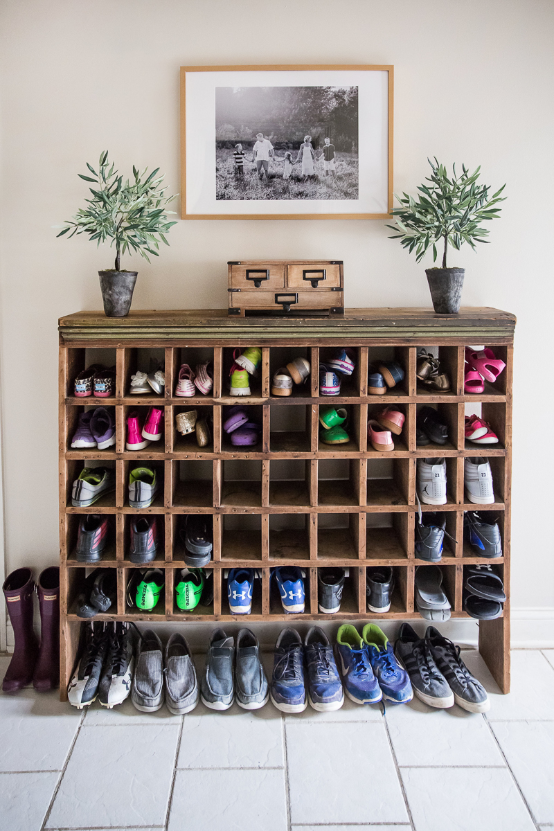 Love this antique mail sorter turned shoe storage in this mudroom kellyelko.com #mudroom #repurpose #thrifted #antique #shoestorage 