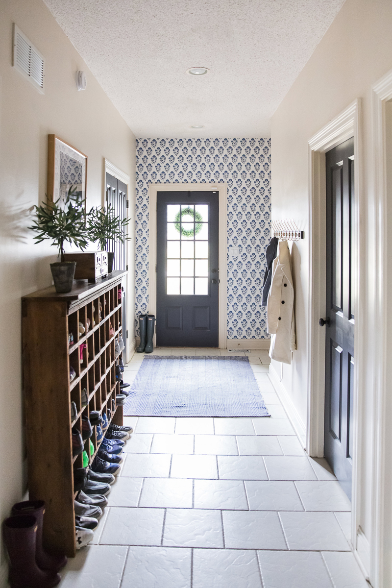 Love this back entry mudroom with blue wallpaper kellyelko.com #mudroom #blue #wallpaper #vintagedecor #farmhousestyle #interiors #interiordecor